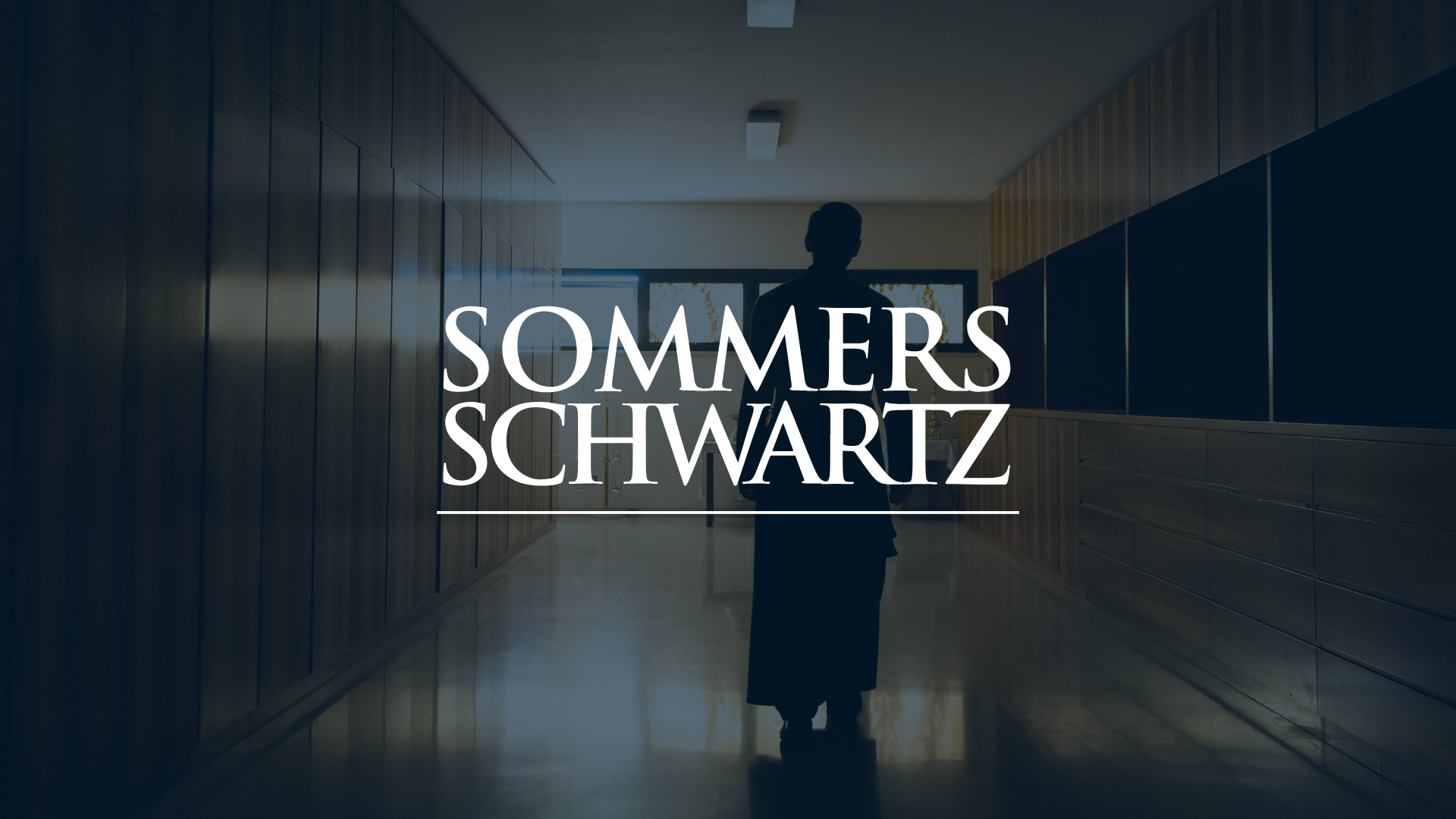 Sommers Schwartz law firm logo overlaid on a darkened hallway with a silhouetted person standing in the distance